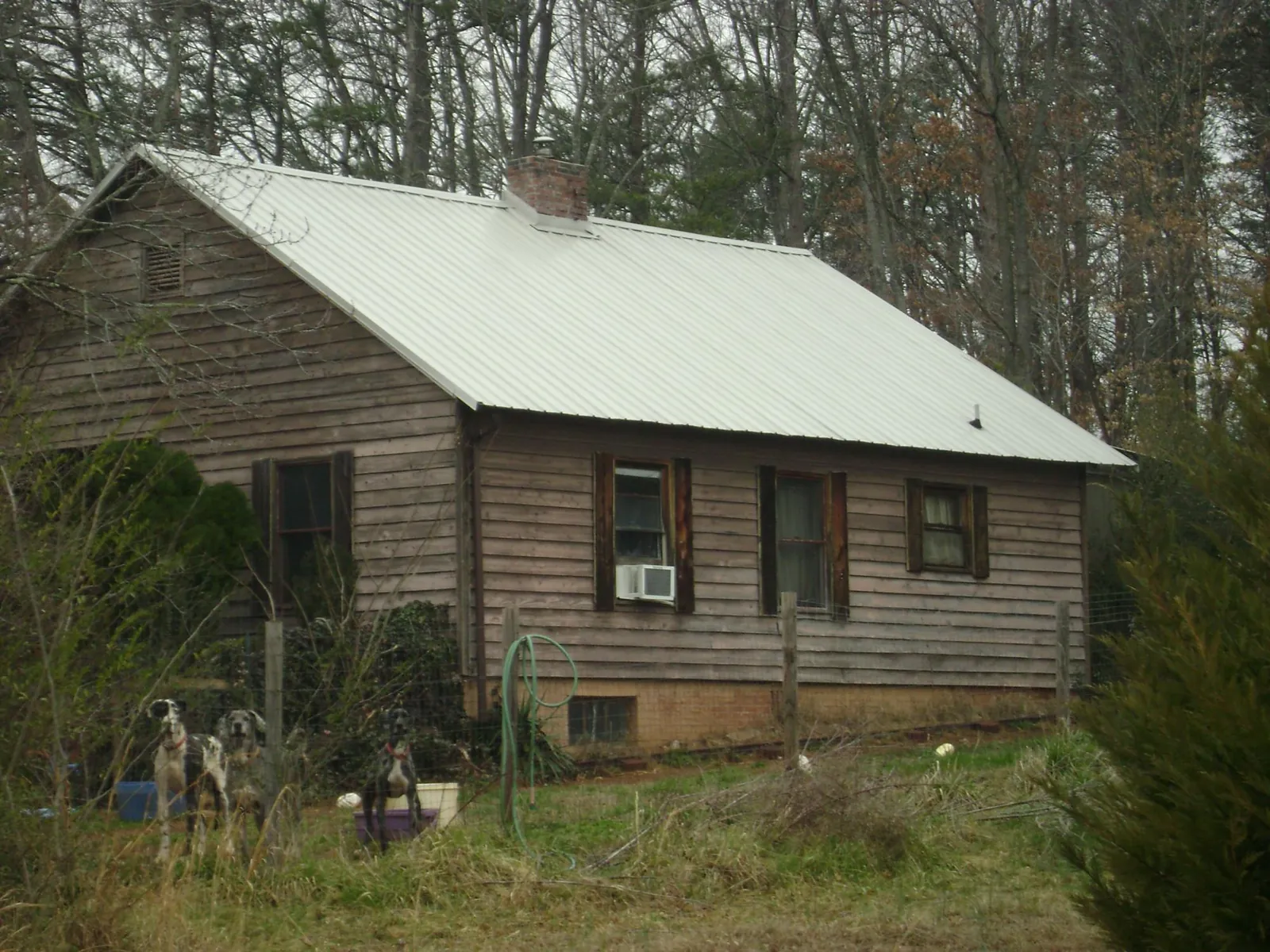 White metal roof on an old wood sided farmhouse, from a Asphalt Shingle Roof Repair job in Southlake